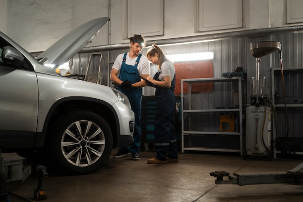 car engine diagnostics by mechanics at an automotive shop